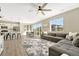 Bright, open-concept living space features a modern kitchen, dining area, and spacious gray sectional sofa at 1886 Makley Loop, Castle Rock, CO 80104