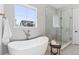 Bright bathroom featuring a soaking tub, and separate glass shower at 1425 Burt Ave, Berthoud, CO 80513