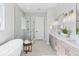 Bright and modern bathroom with double vanity, soaking tub and glass enclosed shower at 1425 Burt Ave, Berthoud, CO 80513