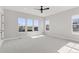 Bright bedroom with a ceiling fan and a view from the large windows at 1425 Burt Ave, Berthoud, CO 80513