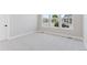 Bright and spacious bedroom with neutral walls, plush carpeting, and a view of the neighborhood at 1425 Burt Ave, Berthoud, CO 80513