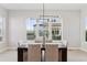 Bright dining area with large windows providing scenic views, modern lighting, and comfortable seating at 1425 Burt Ave, Berthoud, CO 80513