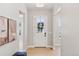 Bright entryway with a white door, hardwood floors, neutral walls, and modern light fixture at 1425 Burt Ave, Berthoud, CO 80513