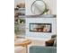 Modern fireplace with a wooden mantel and built-in shelving, enhanced by stylish decor at 1425 Burt Ave, Berthoud, CO 80513