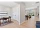 Bright hallway with hardwood floors, neutral walls, and an office to the left, flowing into an open living space at 1425 Burt Ave, Berthoud, CO 80513