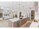 Open-concept kitchen with large island, stainless steel appliances, and seamless connection to the living area at 1425 Burt Ave, Berthoud, CO 80513
