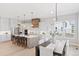 Spacious kitchen with dining area, a kitchen island with pendant lighting, and modern appliances at 1425 Burt Ave, Berthoud, CO 80513