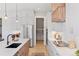 Bright kitchen with stainless steel appliances, white cabinets, and island with a sink and wooden base at 1425 Burt Ave, Berthoud, CO 80513