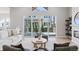 Bright living room with a modern fireplace and large windows overlooking the backyard at 1425 Burt Ave, Berthoud, CO 80513