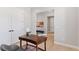 Bright office space featuring neutral decor, hardwood floors, and seamless transition into the hallway at 1425 Burt Ave, Berthoud, CO 80513