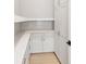 Walk-in pantry featuring white cabinets, countertop, tiled backsplash, and ample storage space at 1425 Burt Ave, Berthoud, CO 80513