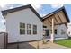 Back exterior showcasing modern design, a covered patio, and a well-manicured yard at 1425 Burt Ave, Berthoud, CO 80513