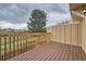 This wooden deck looks out to a grassy landscape with an oversized pine tree in the distance at 1240 S Idalia St, Aurora, CO 80017