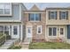 A row of townhomes showcasing unique exteriors with stone and colorful siding, plus well-kept lawns at 1240 S Idalia St, Aurora, CO 80017