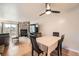 Bright living room with a stone fireplace, ceiling fan, and access to an outdoor deck at 1240 S Idalia St, Aurora, CO 80017