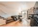 Inviting living room with stone fireplace, wood floors, and a comfortable sectional sofa at 1240 S Idalia St, Aurora, CO 80017