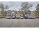 A row of colorful townhomes are lined up along the street, with ample parking in front at 1240 S Idalia St, Aurora, CO 80017