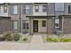 Charming townhome exterior featuring stone pillars, neutral siding, covered porch, and a well-maintained walkway at 19733 W 93Rd Ln # D, Arvada, CO 80007