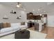 Inviting living room with modern furnishings, open layout, and seamlessly connected to a stylish, well-equipped kitchen at 19733 W 93Rd Ln # D, Arvada, CO 80007