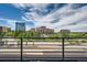 Balcony view of city buildings, trees, and road with passing vehicles at 8100 E Union Ave # 310, Denver, CO 80237