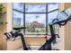 Exercise bike sits in front of bay window with expansive city views at 8100 E Union Ave # 310, Denver, CO 80237