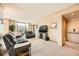 The spacious living room features neutral tones, a large window with a view, and comfortable seating arrangement at 8100 E Union Ave # 310, Denver, CO 80237