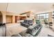 Open-concept living area with a combined seating area and kitchen featuring carpet floors and large windows at 8100 E Union Ave # 310, Denver, CO 80237