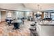 Resident's lounge area with a kitchenette, dark wood cabinets, multiple tables, and plush seating at 8100 E Union Ave # 310, Denver, CO 80237