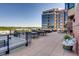 Rooftop deck with black metal furniture, large building views, and green landscaping at 8100 E Union Ave # 310, Denver, CO 80237
