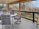 Enjoy outdoor dining on this covered deck featuring a table, chairs, and a grill, perfect for entertaining guests at 14475 Crabapple Rd, Golden, CO 80401