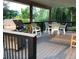 Large outdoor deck with grill, table, and chairs offers ample space for entertaining and enjoying the backyard at 14475 Crabapple Rd, Golden, CO 80401
