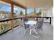 Relax on this covered back deck with a dining table set, offering a tranquil outdoor space with scenic views at 14475 Crabapple Rd, Golden, CO 80401