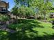 Expansive backyard with mature trees, lush lawn, and stone pathways, perfect for outdoor relaxation at 14475 Crabapple Rd, Golden, CO 80401