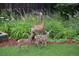 Deer and fawns in a well maintained backyard with lush green grass and verdant foliage at 14475 Crabapple Rd, Golden, CO 80401