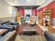 Finished basement with unique decor, comfortable seating, and desk area with exposed ceiling at 14475 Crabapple Rd, Golden, CO 80401