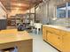 Finished basement with shelving, storage, sink, and workbench at 14475 Crabapple Rd, Golden, CO 80401