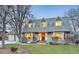 Charming two-story home with a well-manicured lawn, complemented by mature trees and a welcoming entrance at 14475 Crabapple Rd, Golden, CO 80401