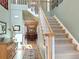 Inviting foyer featuring hardwood floors, a staircase, and a view into the dining room at 14475 Crabapple Rd, Golden, CO 80401