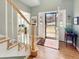 Sunlit foyer with hardwood floors, staircase, and an open front door leading to the exterior at 14475 Crabapple Rd, Golden, CO 80401