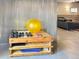 Home gym features dumbbells, exercise ball, wood shelving, and a view into the home's open floor plan at 14475 Crabapple Rd, Golden, CO 80401