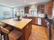 Well-lit kitchen featuring a butcher block island, stainless steel appliances, and an adjacent dining area at 14475 Crabapple Rd, Golden, CO 80401