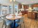Open kitchen and dining area featuring wooden cabinets, a butcher block island, and natural light at 14475 Crabapple Rd, Golden, CO 80401