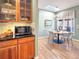 Adjacent breakfast nook featuring wooden cabinets, a microwave, and natural light from the skylight at 14475 Crabapple Rd, Golden, CO 80401