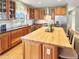 Spacious kitchen with wooden cabinets, stainless steel appliances, butcher block island and tiled backsplash at 14475 Crabapple Rd, Golden, CO 80401
