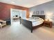 Cozy main bedroom featuring exposed brick and large windows at 14475 Crabapple Rd, Golden, CO 80401
