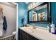 Blue bathroom featuring sink, black vanity, and walk-in closet at 2016 W 101St Ave, Thornton, CO 80260
