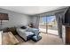 Carpeted bedroom featuring large window with view of the outdoors and a queen bed at 2016 W 101St Ave, Thornton, CO 80260
