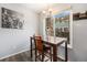 Cozy dining area with dark wood table set by a large window with neighborhood views at 2016 W 101St Ave, Thornton, CO 80260