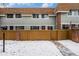 Charming townhouse with wood fence, and brick accents; covered in fresh snow at 2016 W 101St Ave, Thornton, CO 80260