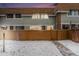 Charming townhouse with a fenced yard, brick accents, and pathway in winter at 2016 W 101St Ave, Thornton, CO 80260